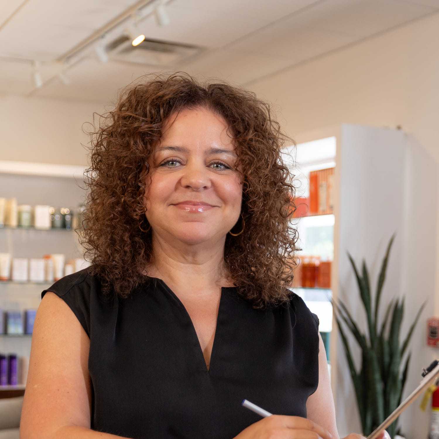 Portrait of Alicia, a professional stylist at Esmeralda’s Beauty Bar, showcasing their expertise and style.