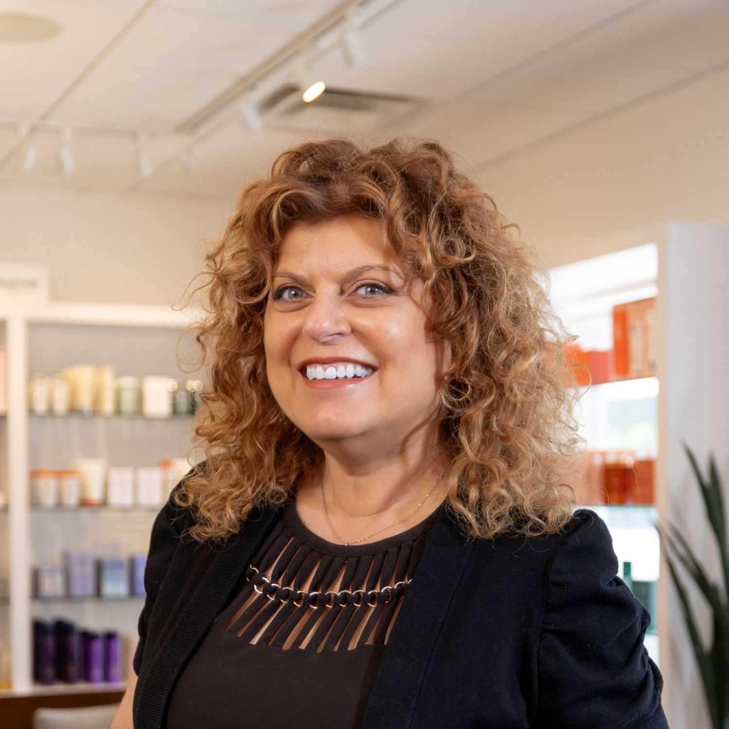 Portrait of Maria, a professional stylist at Esmeralda’s Beauty Bar, showcasing their expertise and style.