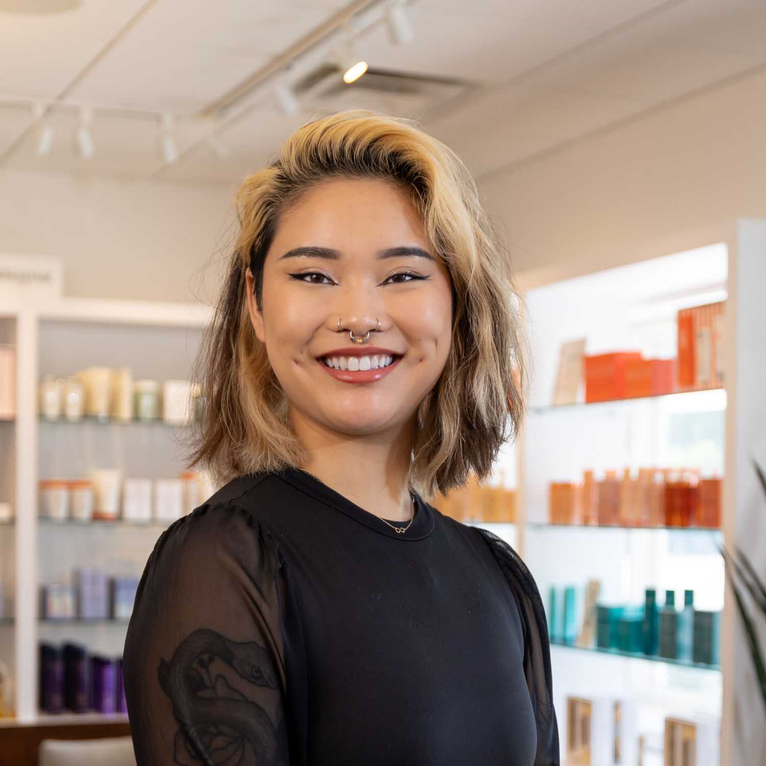 Portrait of Mayson, a professional stylist at Esmeralda’s Beauty Bar, showcasing their expertise and style.