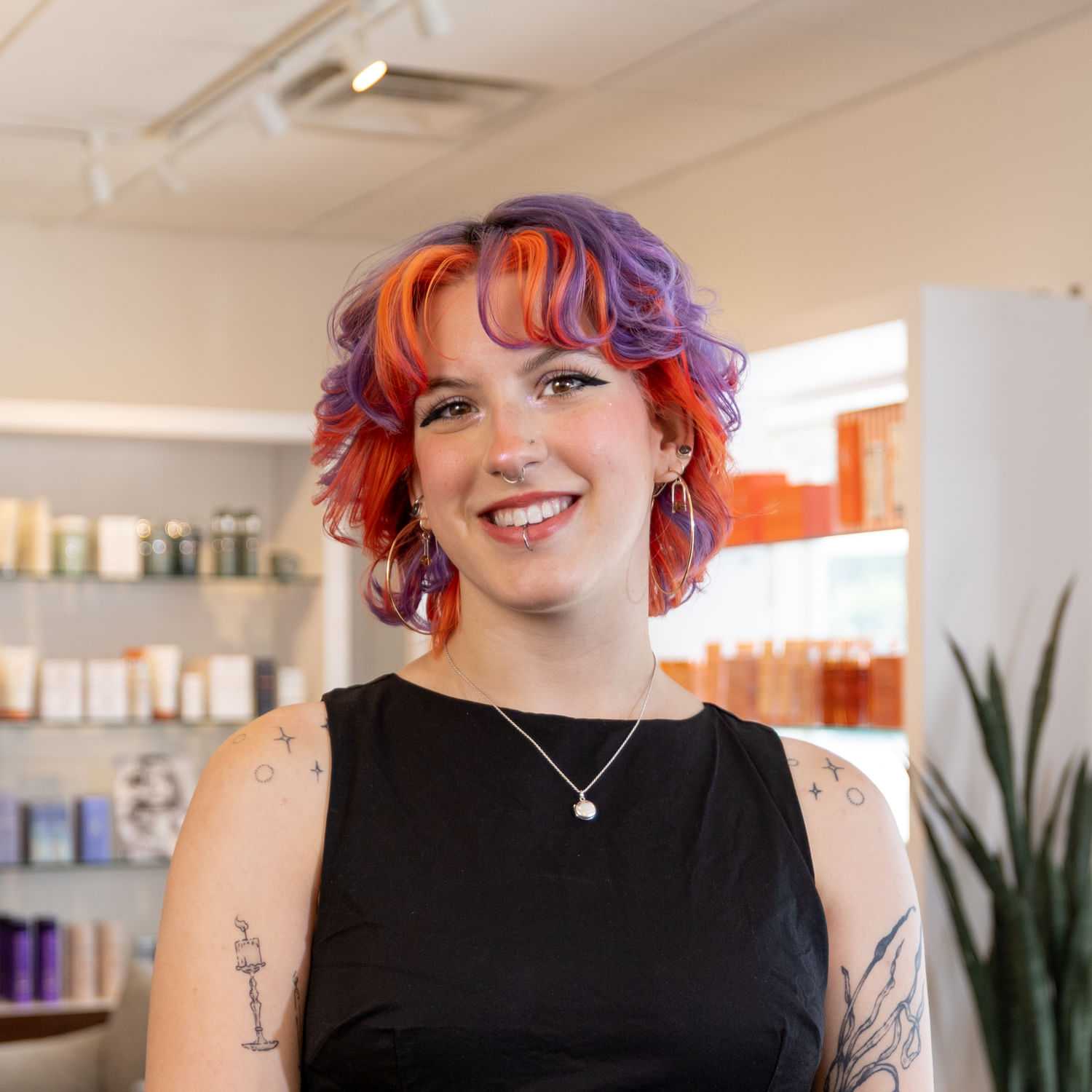 Portrait of Cedar, a professional stylist at Esmeralda’s Beauty Bar, showcasing their expertise and style.