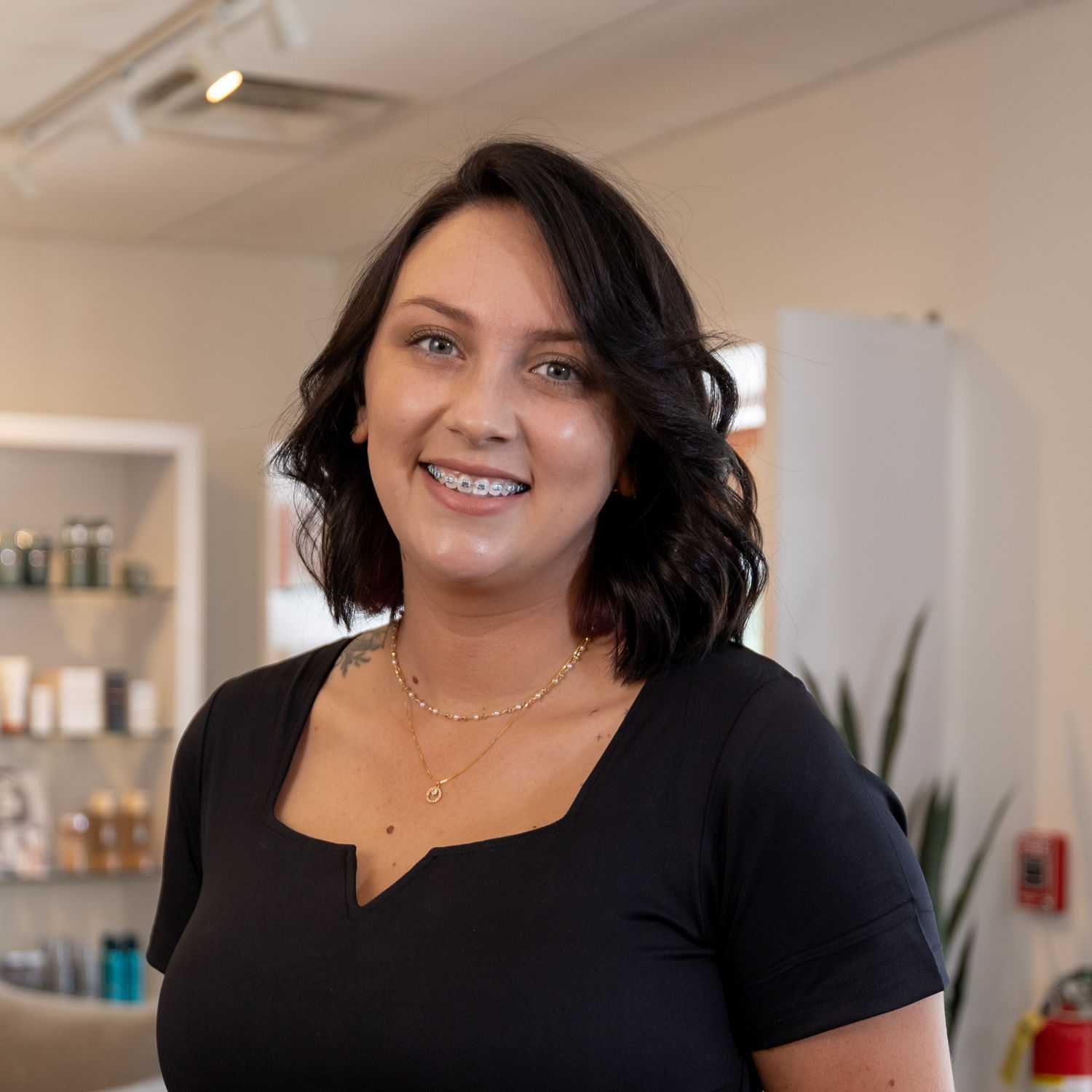 Portrait of Taylor, a professional stylist at Esmeralda’s Beauty Bar, showcasing their expertise and style.